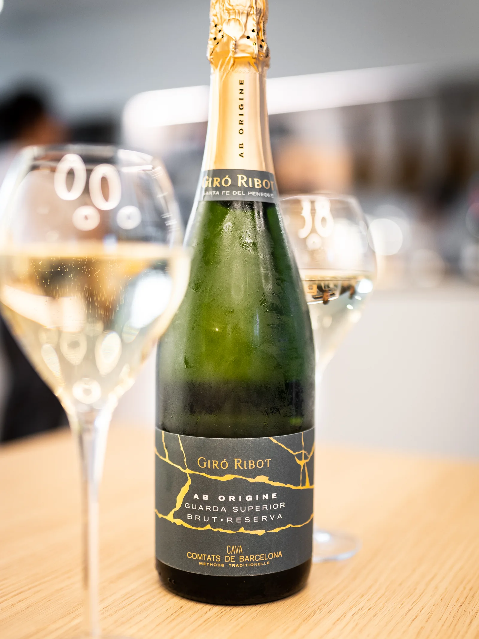 Bottle of Spanish cava and two glasses on the bar at LA DULA Geneva